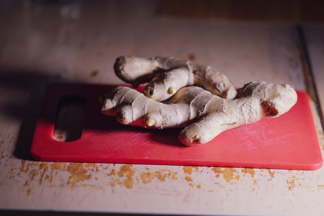Closeup of ginger on a red cutting board