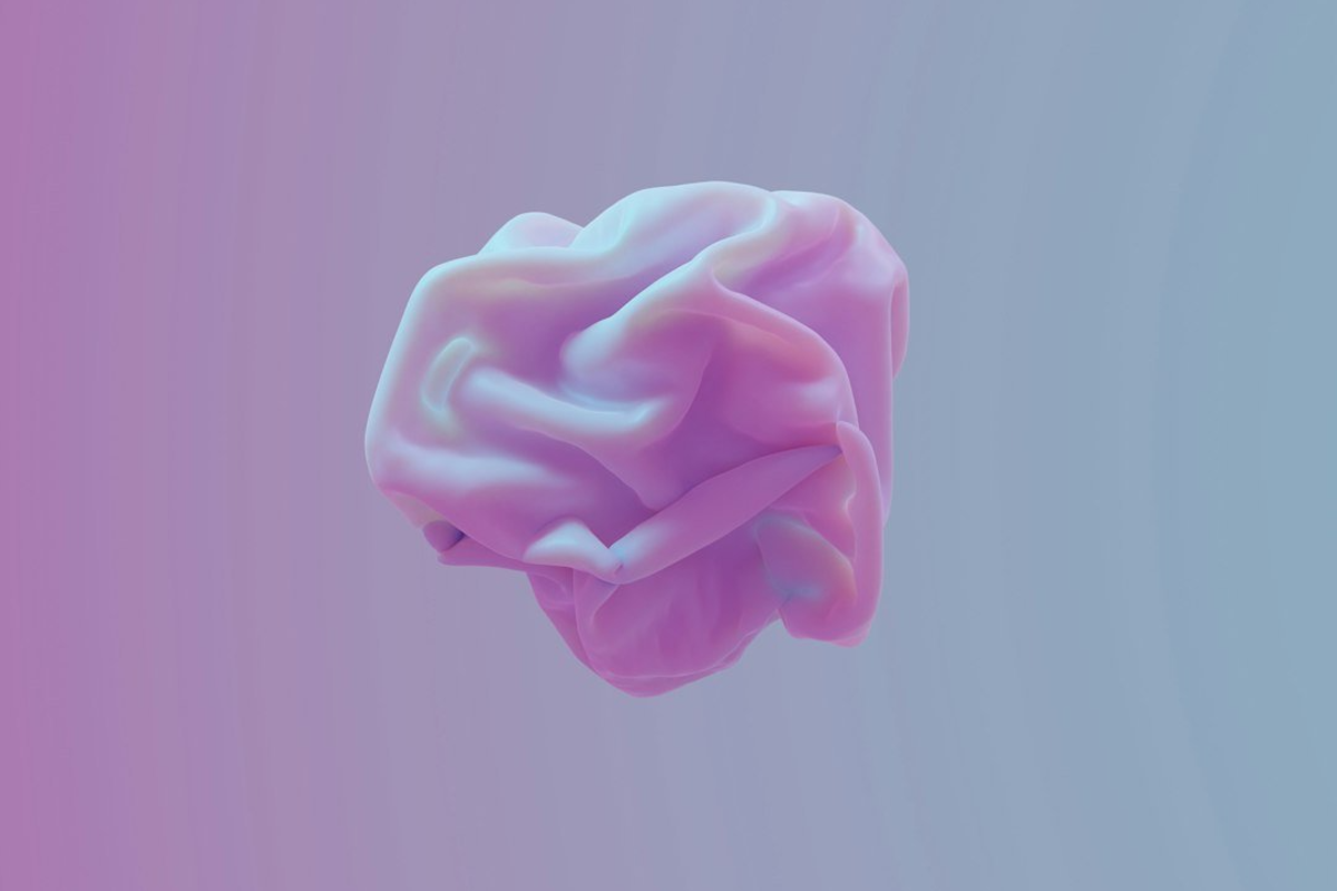 Gradiant image from hot pink to green with an abstract image of a stomach floating in the center. 
