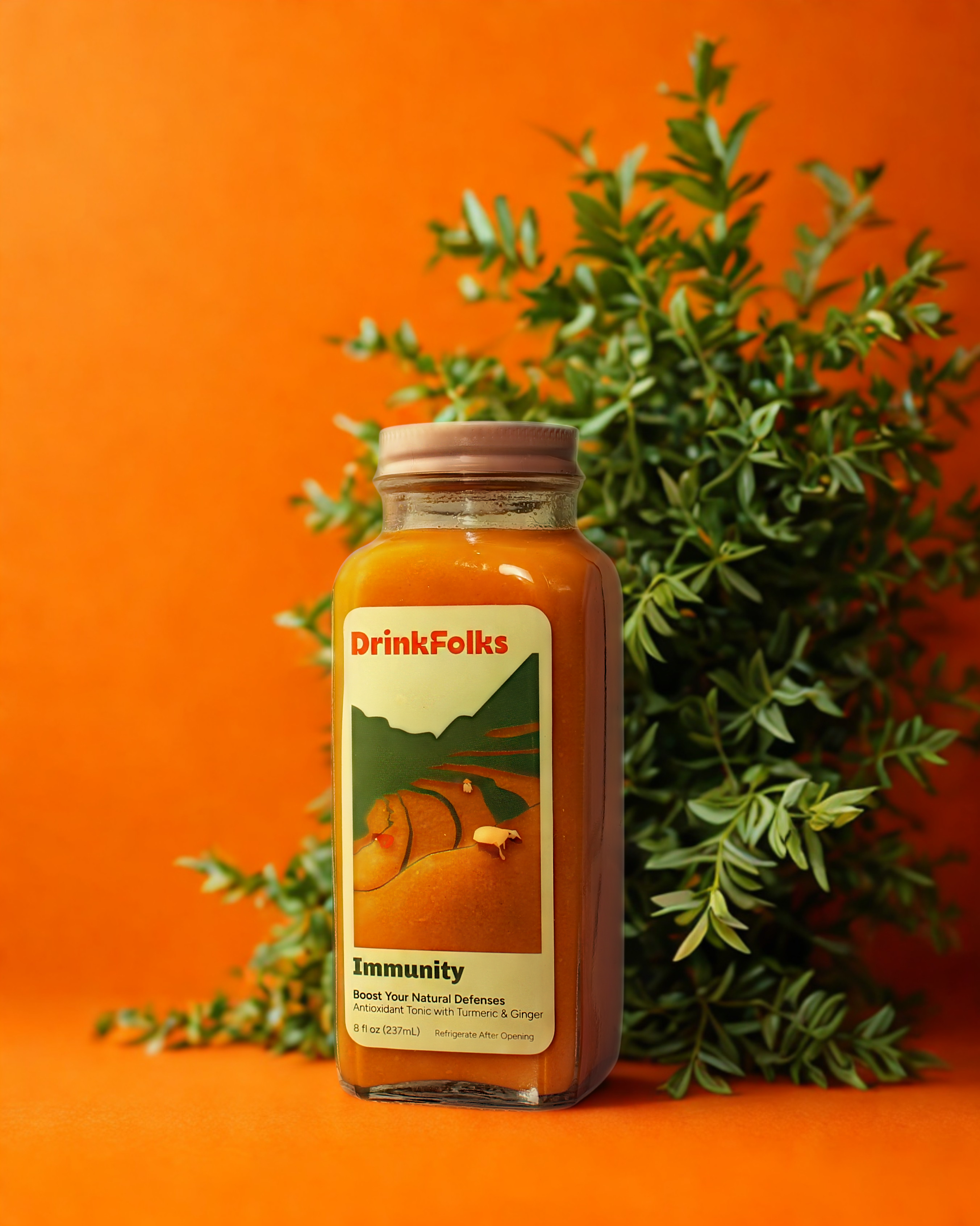 Bottle of DrinkFolks Immunity juice with an orange background and green leaves.
